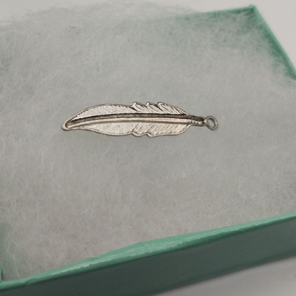 Silver feather charm